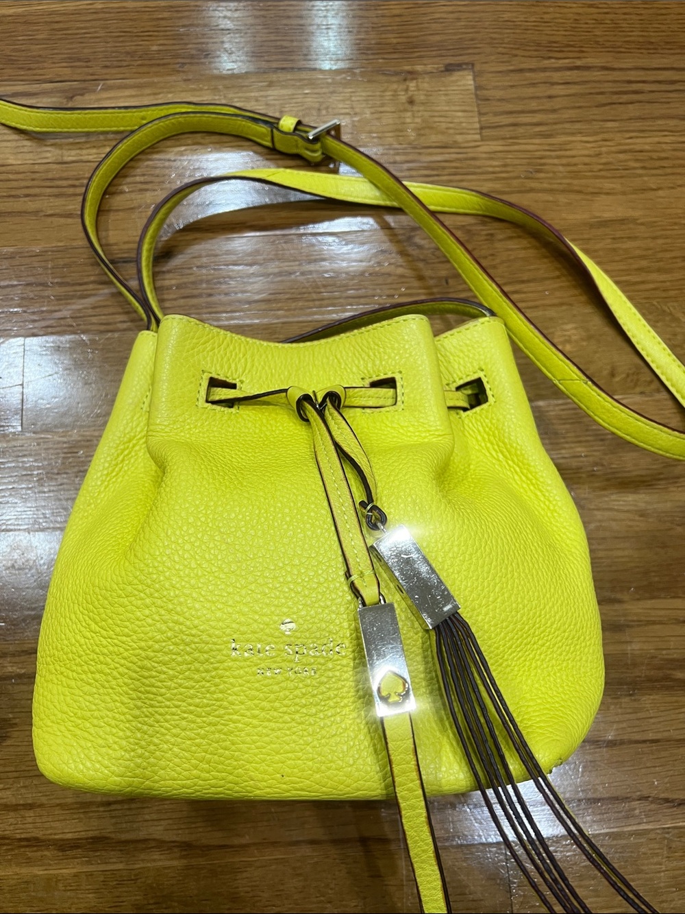 kate spade yellow pebbled leather drawstring crossbody with tassel